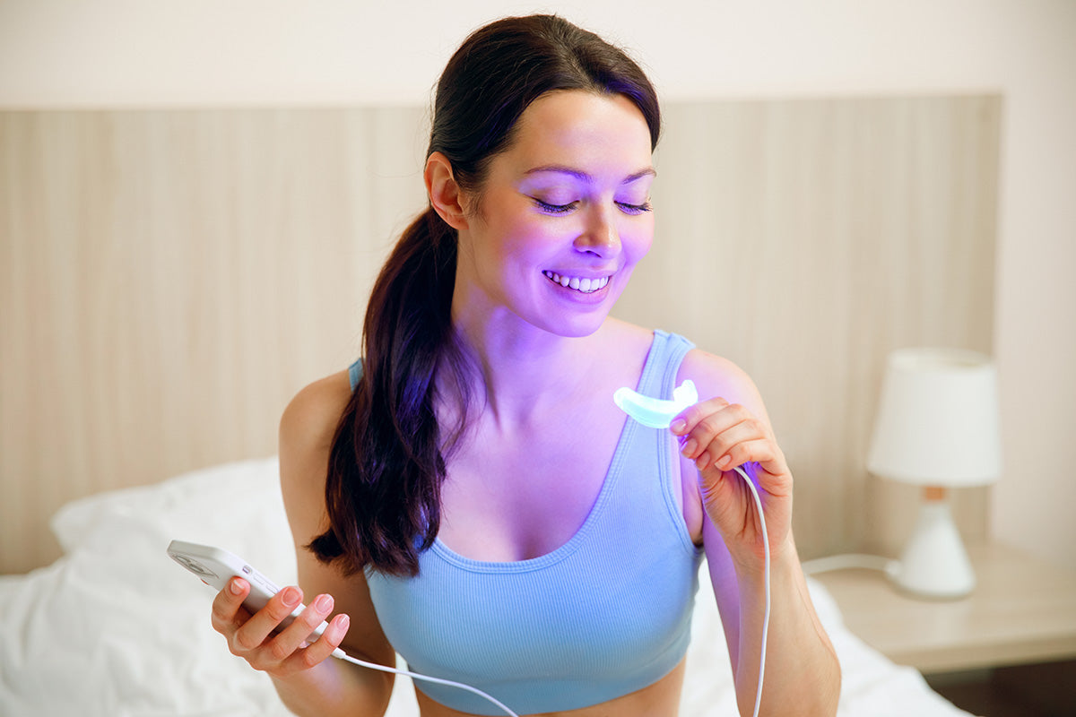Smile Bright Gilr Using LED Mouth Tray for Teeth Whitening